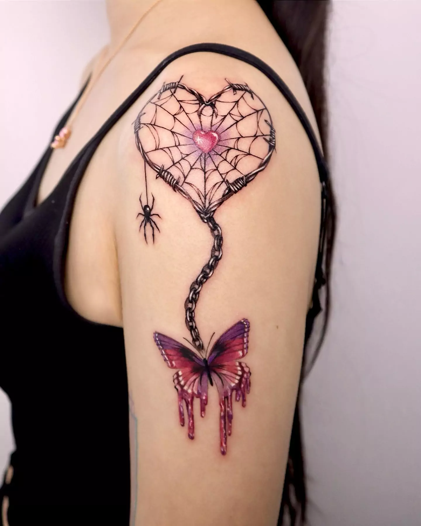 butterfly and heart shaped spider web tattoo