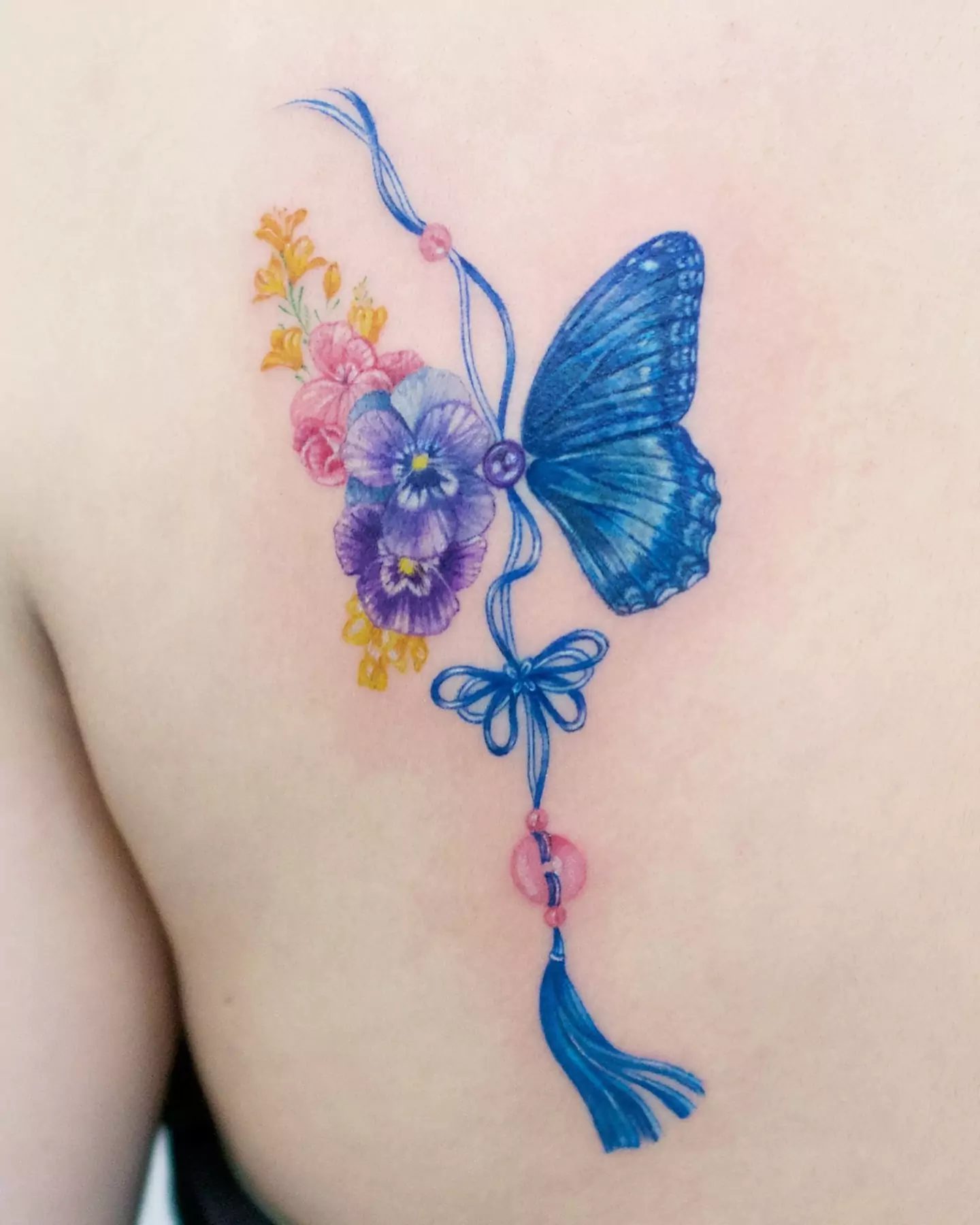 colorful butterfly tattoo on back