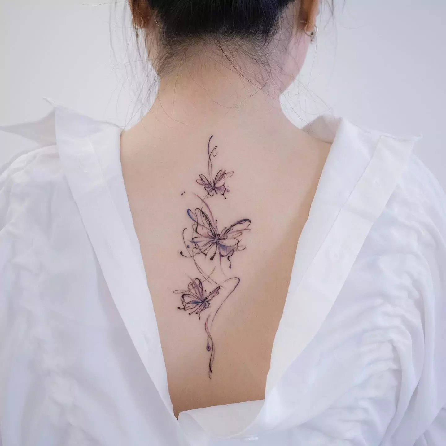 creative butterfly back tattoo