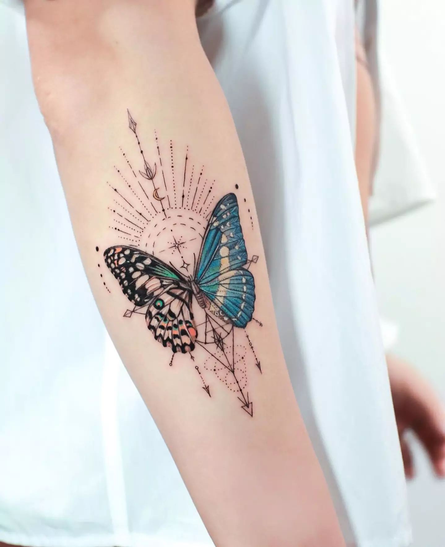 realistic and colorful butterfly tattoo on hand