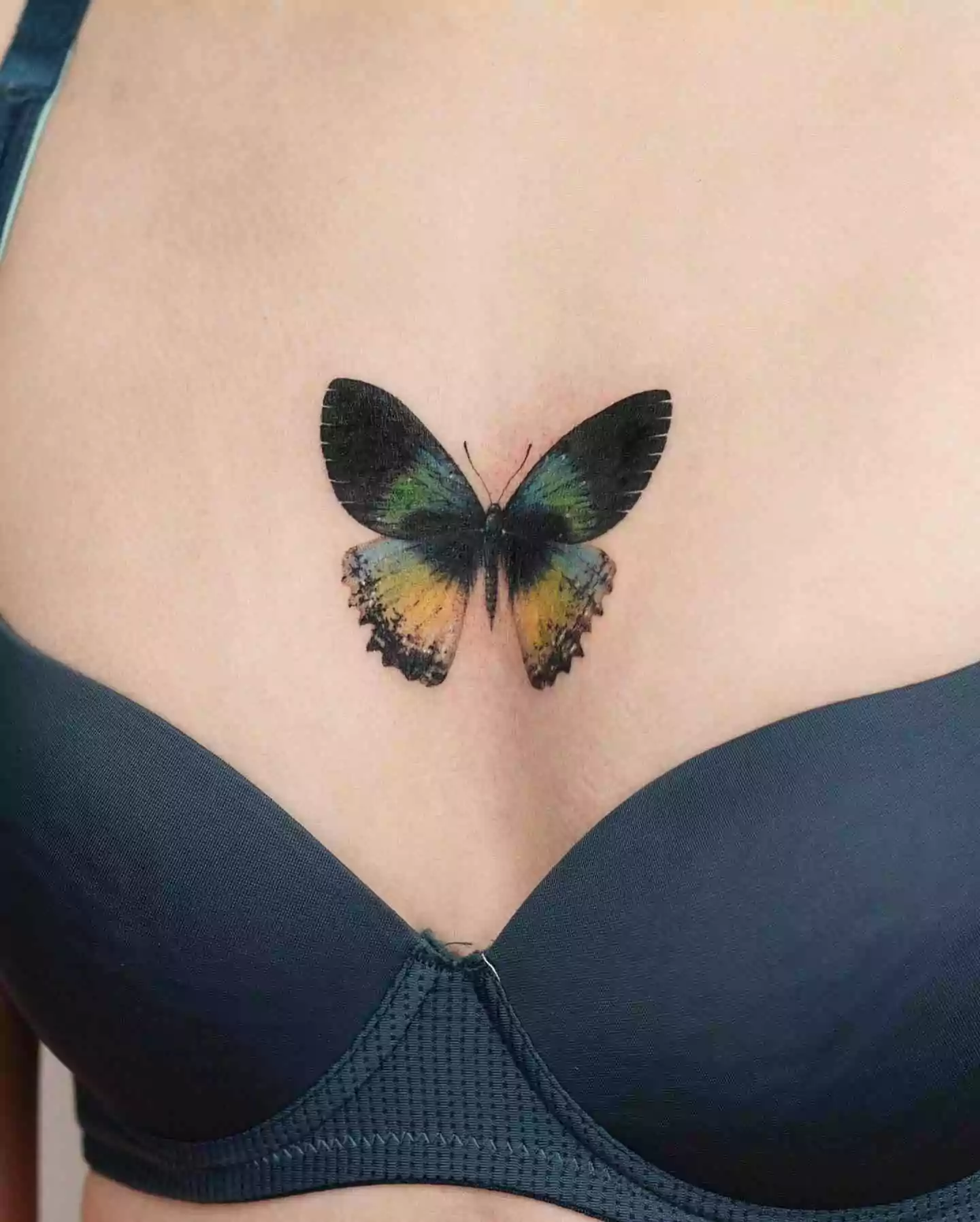 realistic butterfly sternum tattoo