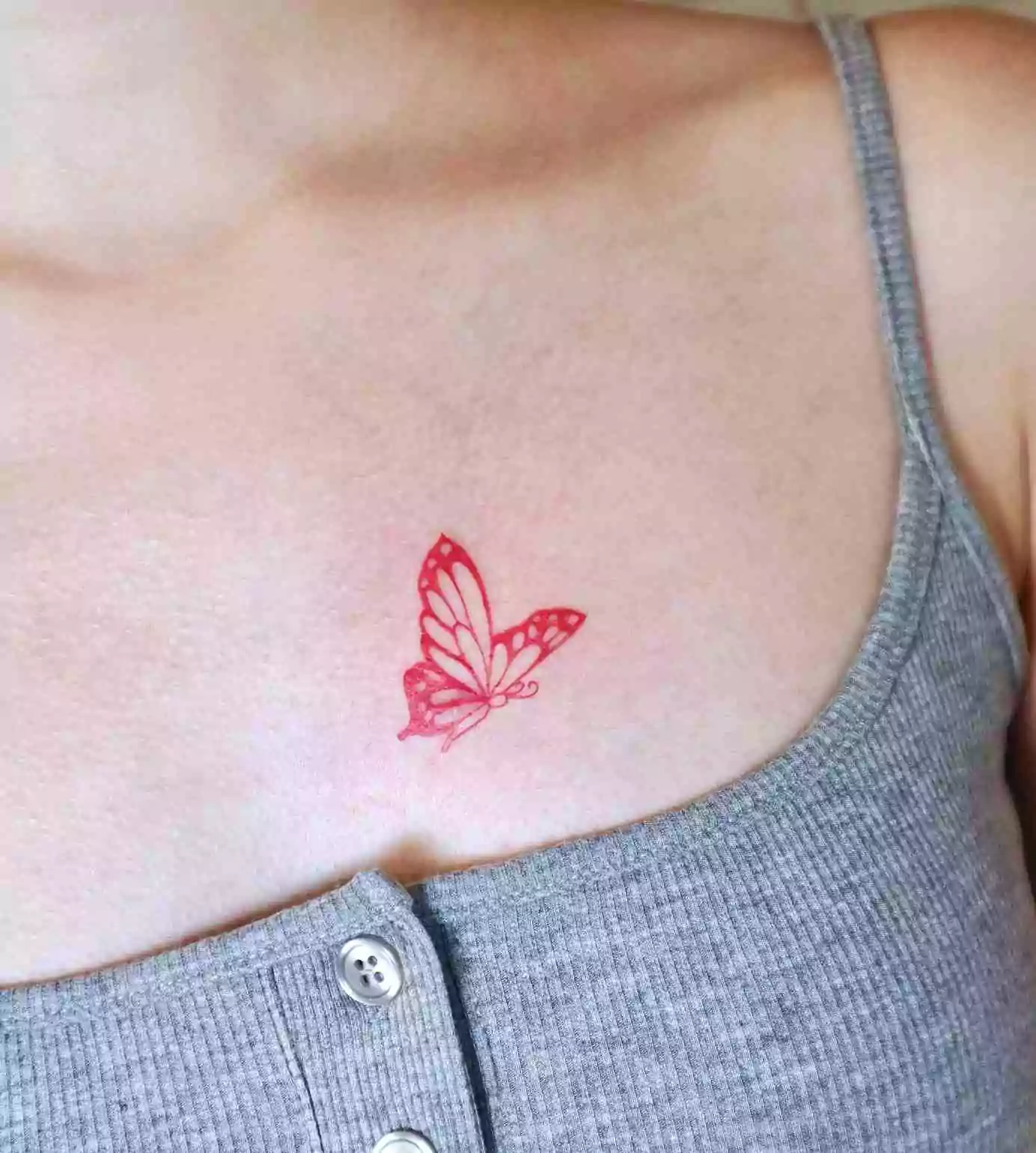 red color butterfly tattoo on chest