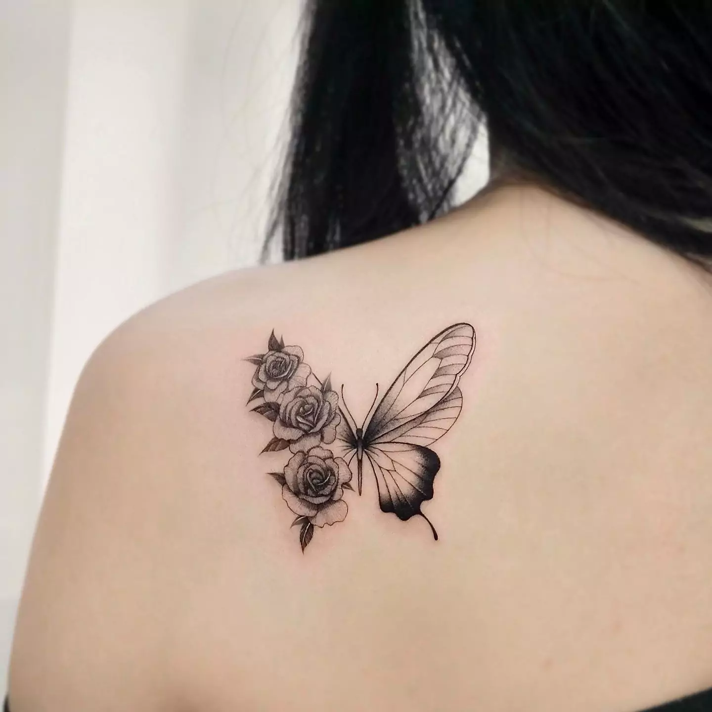 rose and butterfly back tattoo