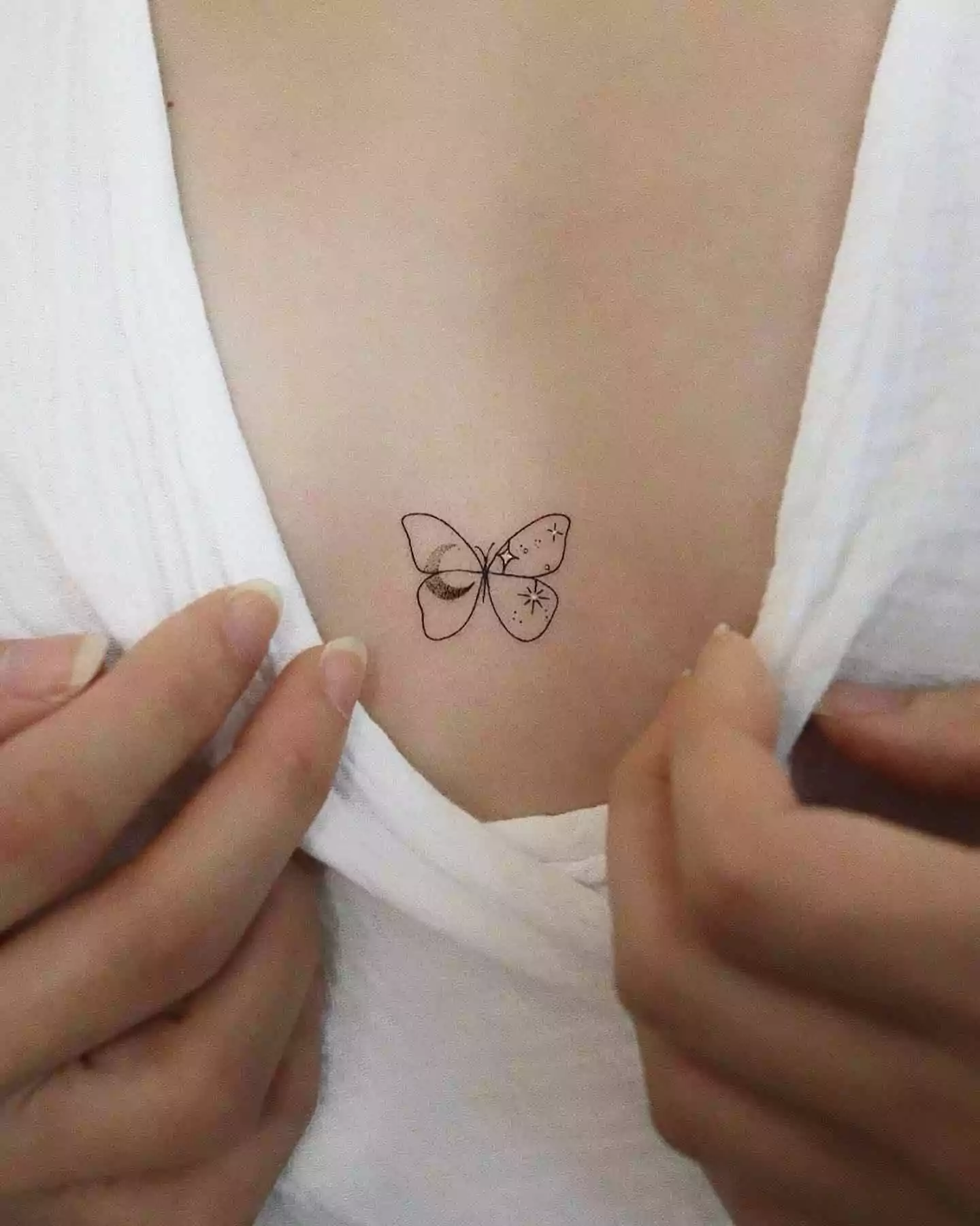 small and cute butterfly sternum tattoo