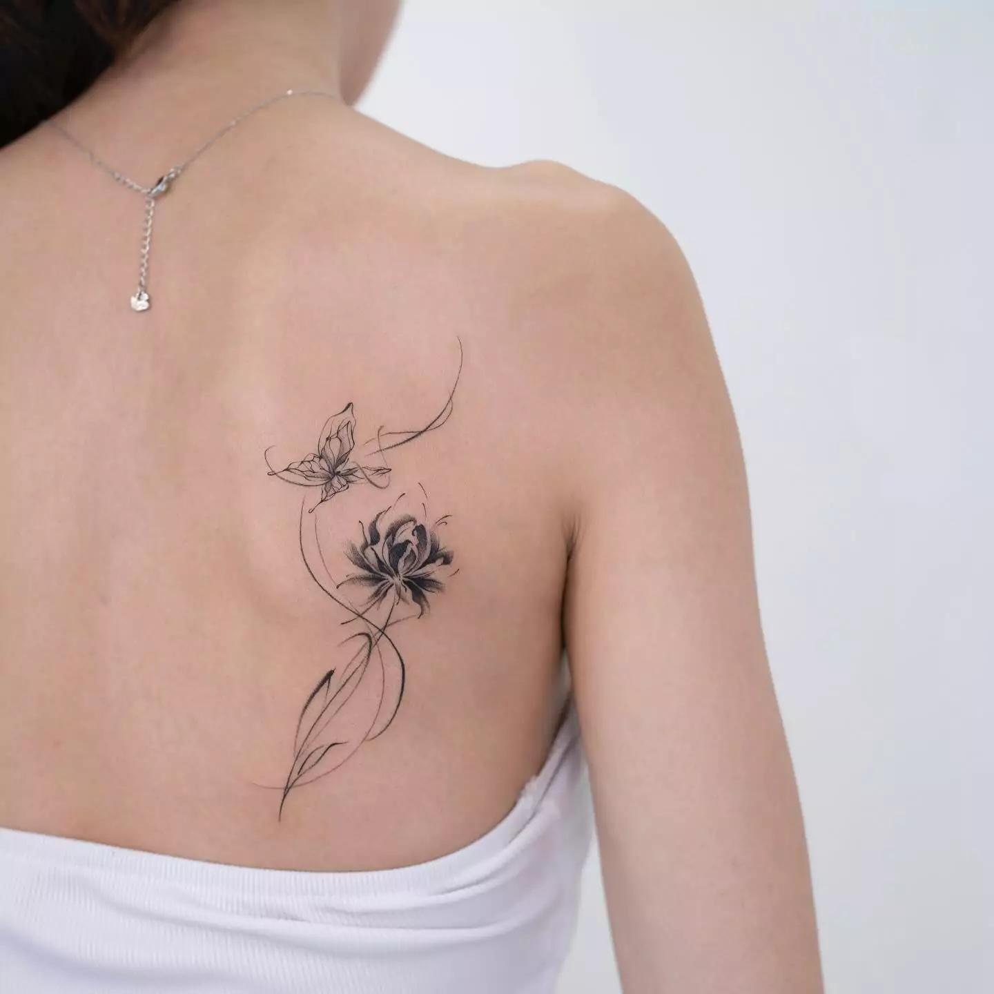 spider lily and butterfly tattoo