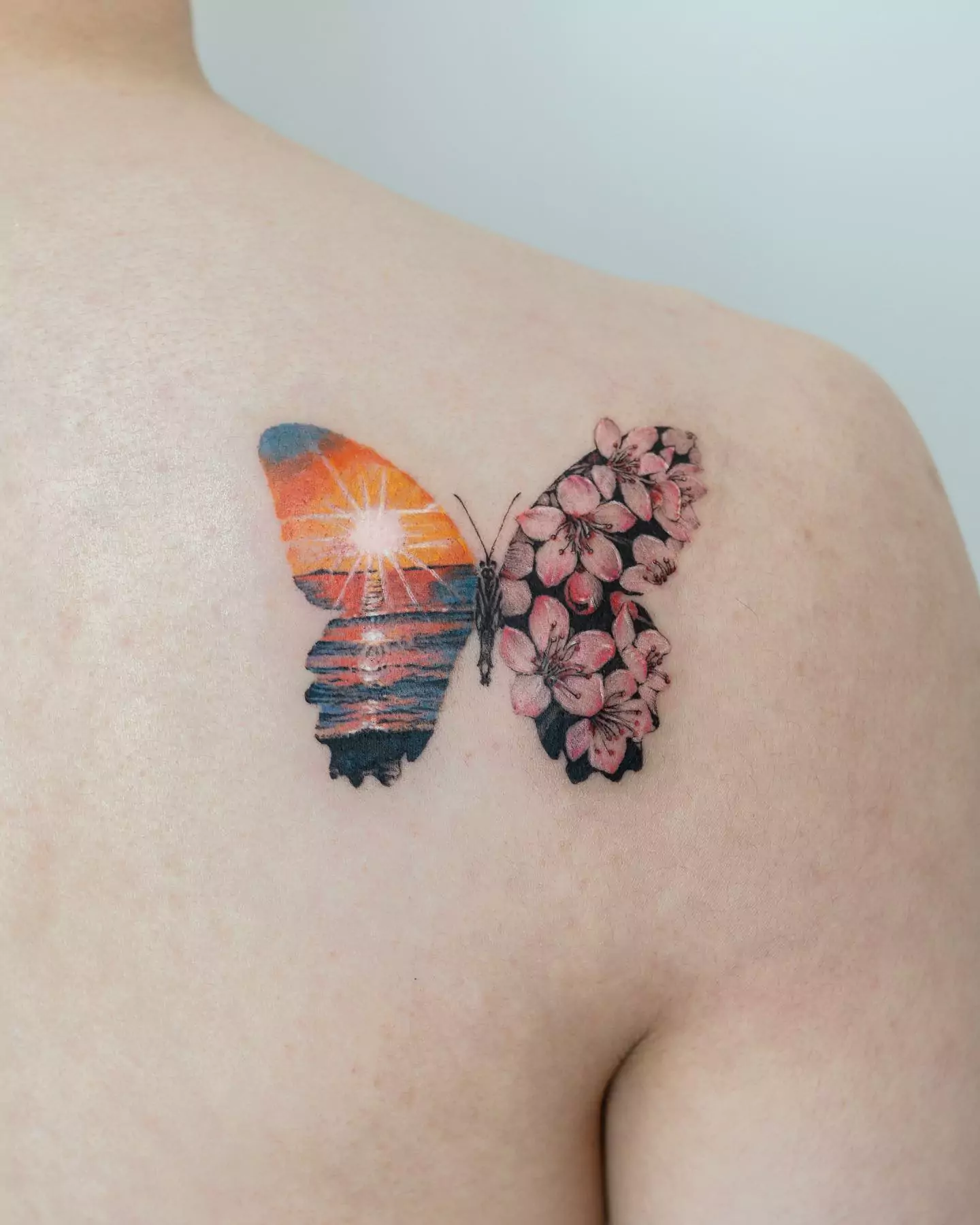 sunrise and butterfly tattoo