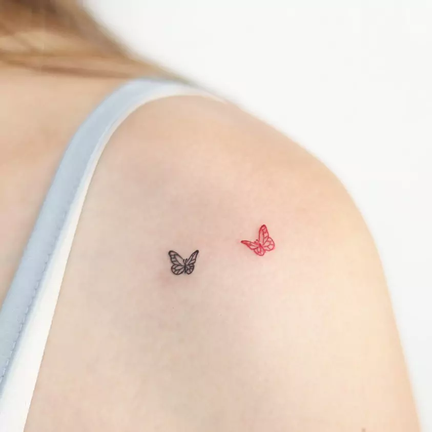 tiny butterfly hand tattoo