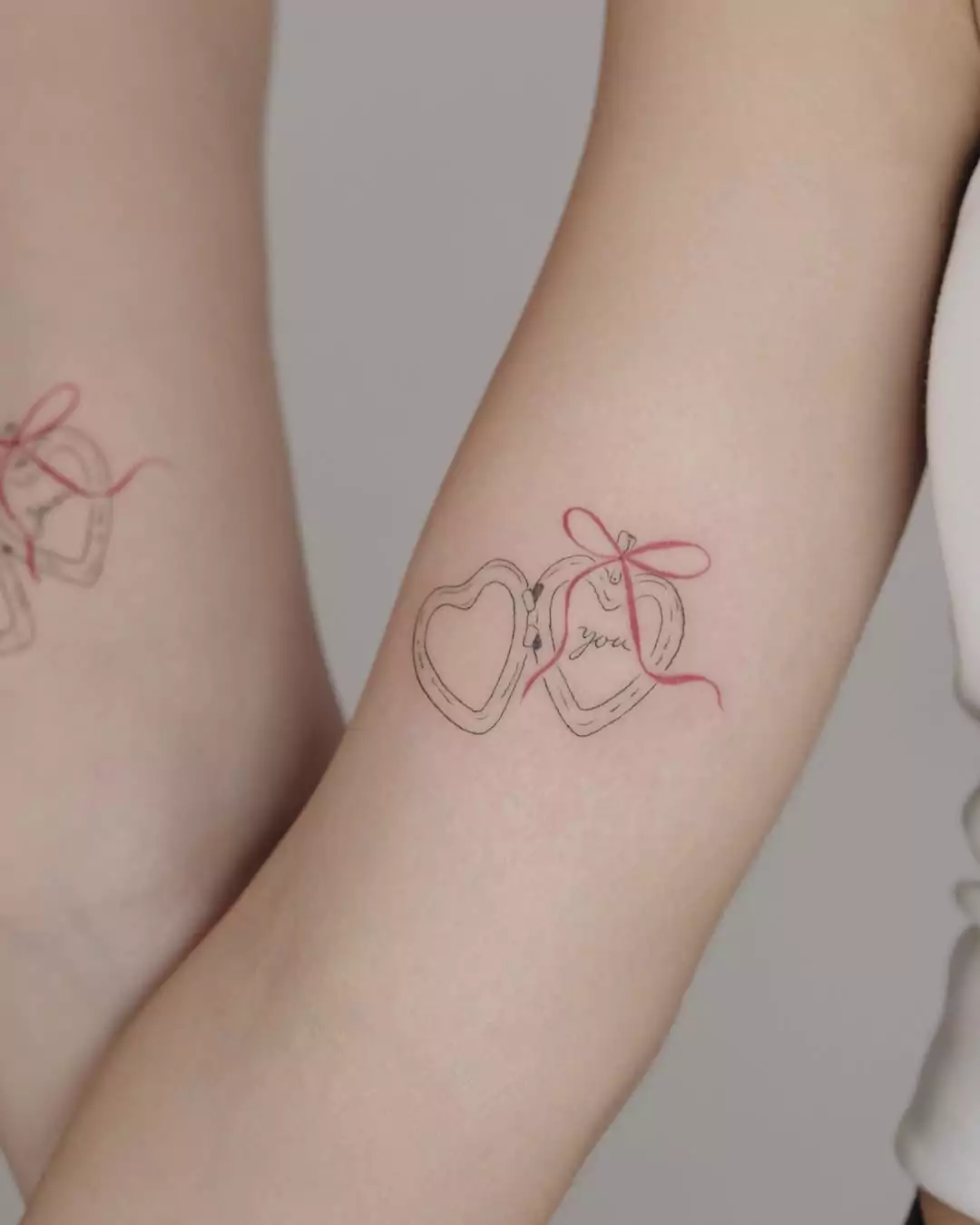 Matching Line Art heart symbol tattoos for best friends