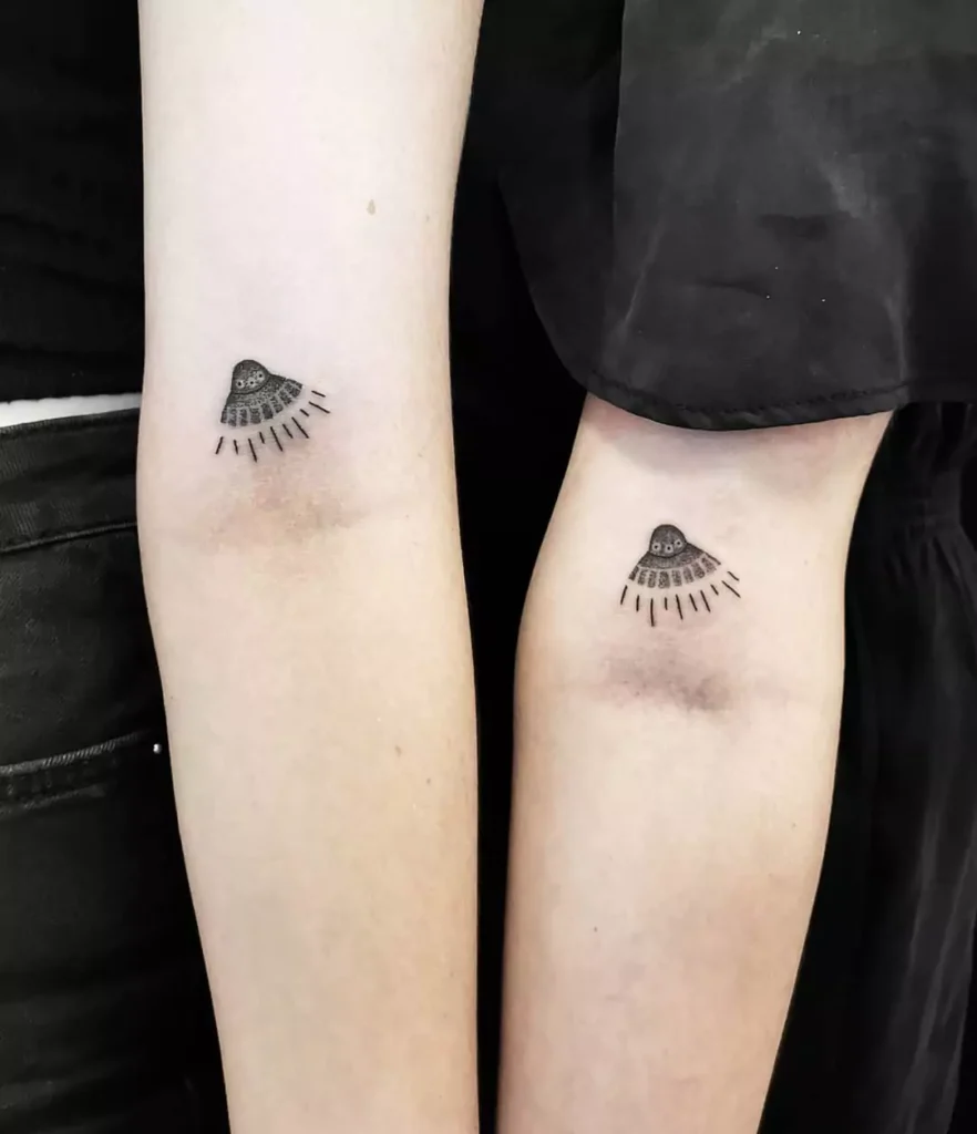 Matching UFO tattoos
