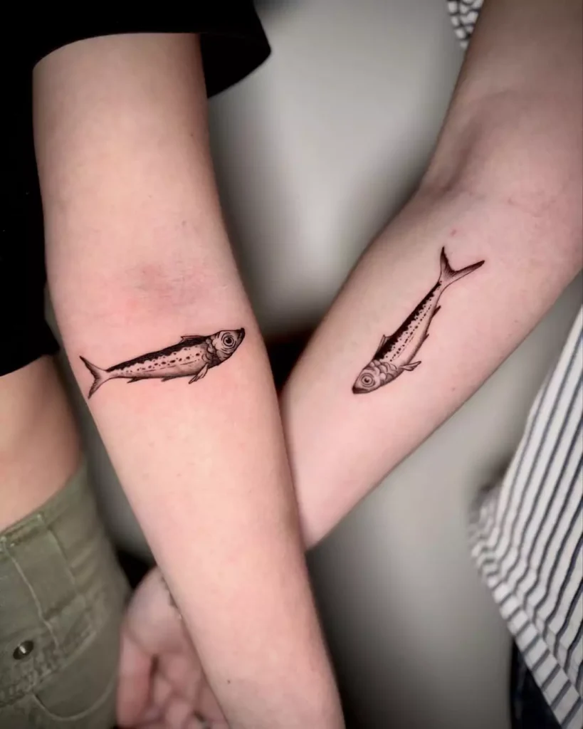 Matching black fish tattoos for best friends