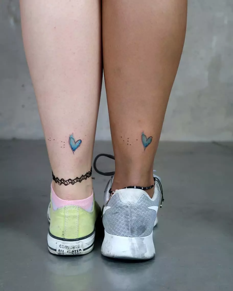 matching heart symbol leg tattoos for friends